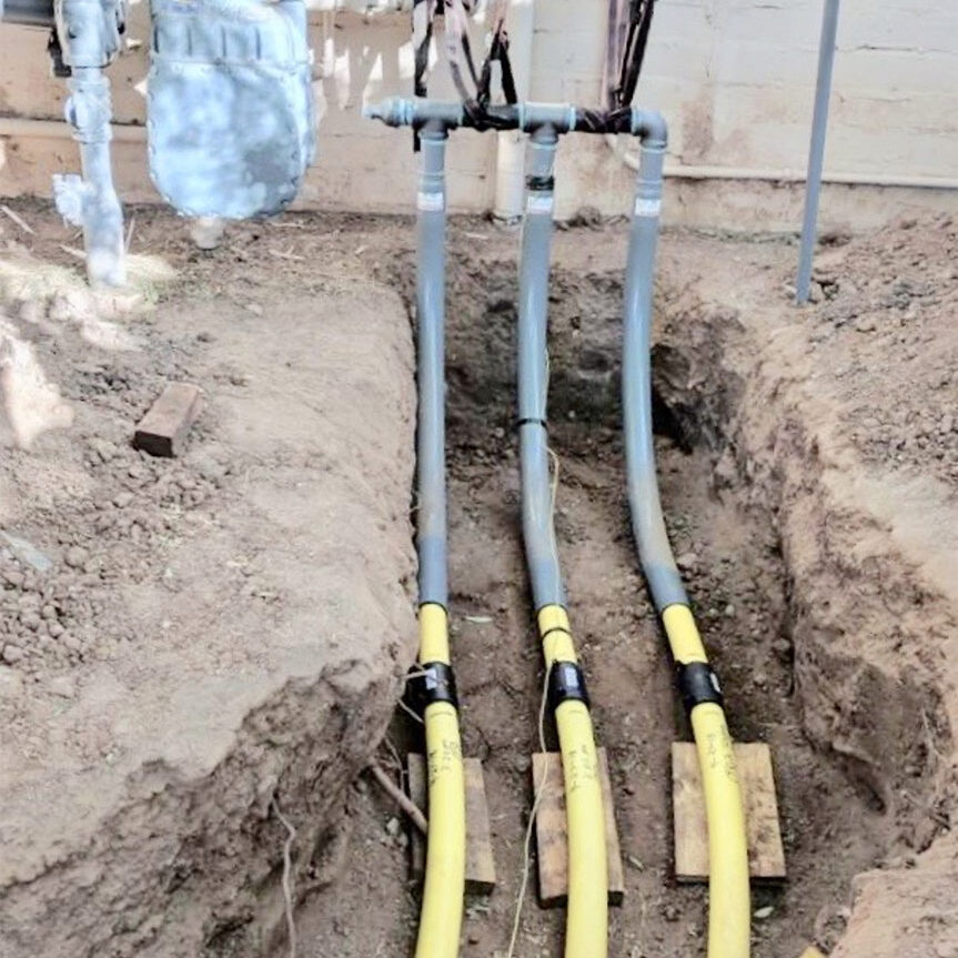 Photo of Liberty-Gandy project, three gas pipes going into a home underground, showing how they are masters of natural gas line repair near me